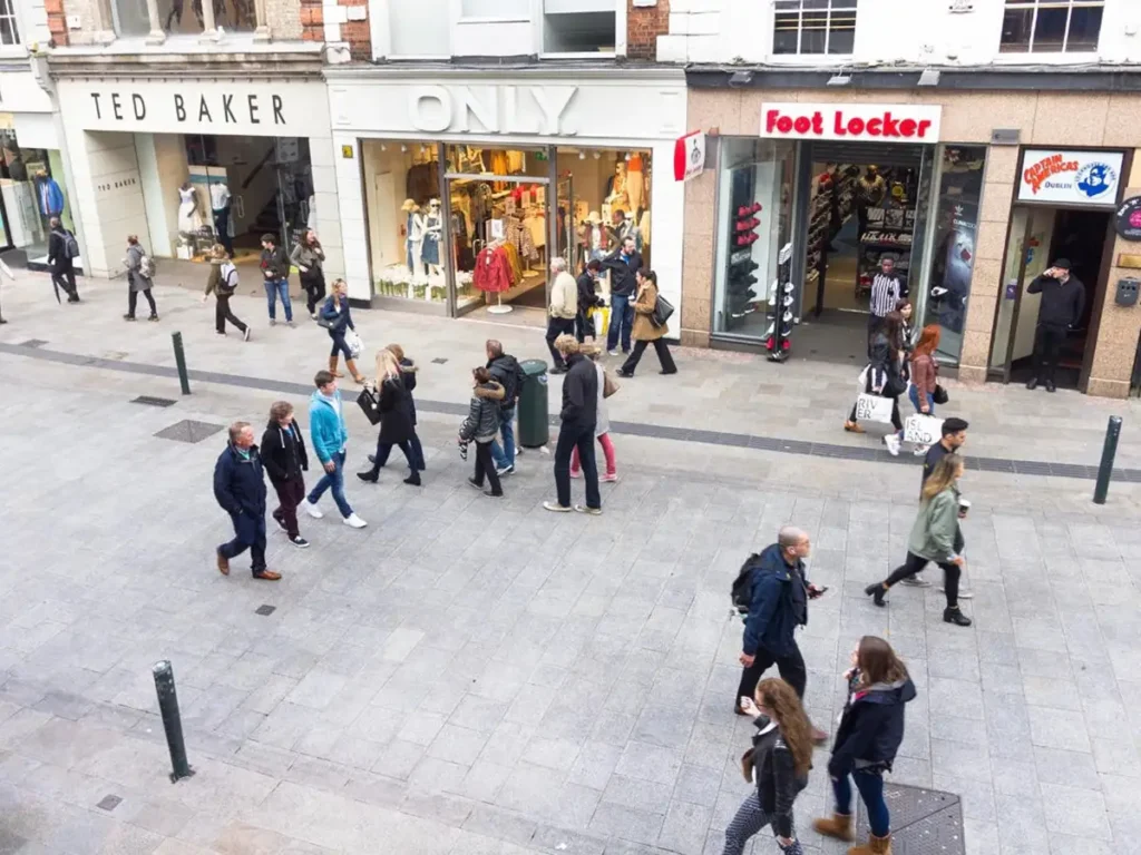 a group of people walking in a retail street